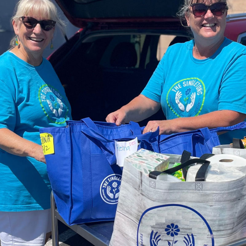 two people with bags